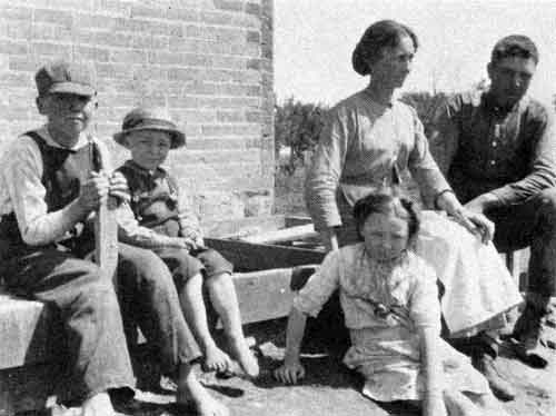 Frank Grain's farm, NE27, Tp. 2, 10W, near Purves, Manitoba, 9 June 1918. Left to right: Roy, William, Laura, Mrs. Elizabeth Grain and Frank.