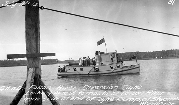Marine excursion, 1914. The steamboat Wanderer with a complement of passengers, including several women, passes a dike under construction near the mouth of the Falcon River on Indian Bay.