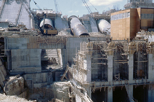 A view of the powerhouse and penstocks, as viewed from the tailrace area, under construction at the future Grand Rapids Generating Station (1963)