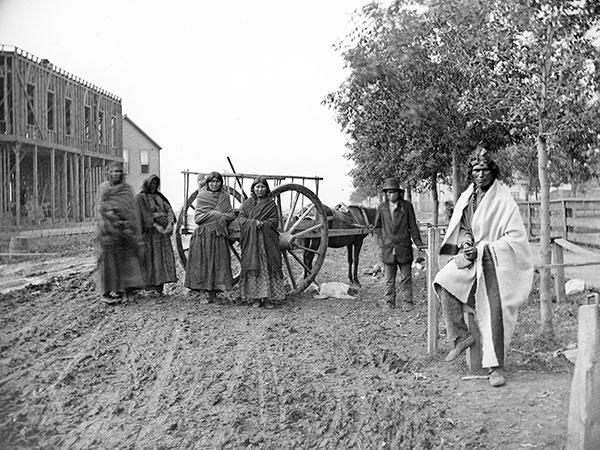 Indigenous people with Red River Cart on Notre Dame Avenue
