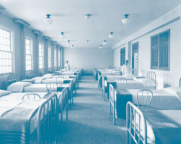 Nurses in one of the wards of the Manitoba School for Mental Defectives at Portage la Prairie, c1930s.