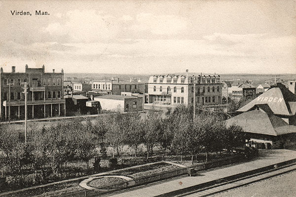 Postcard view of Alexandra Hotel at right background with CPR station at right