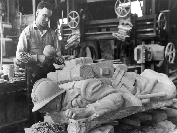 Sculptor Hubert Garnier works on his figure of a fallen soldier for the Belgian War Memorial