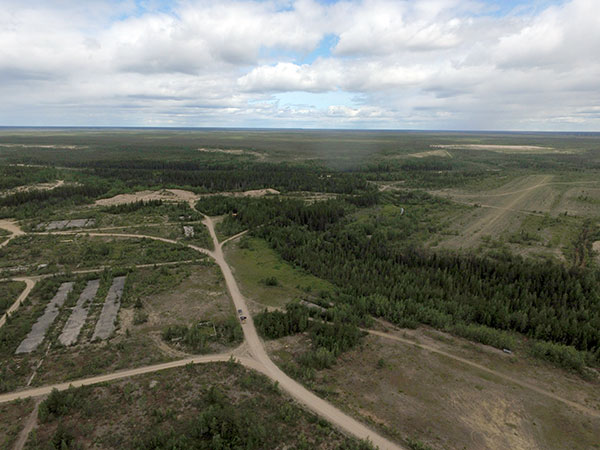Aerial view of the former RCAF Station Bird with the sites of buildings at left and runway at right