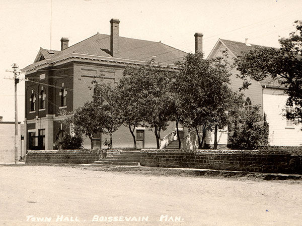 Postcard view of the St. Andrew’s Presbyterian Church with the Boissevain Town Hall at left