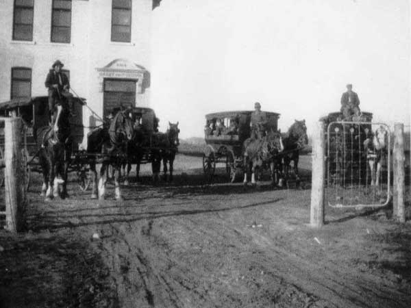 Horse-drawn vans used to transport students to Brant School