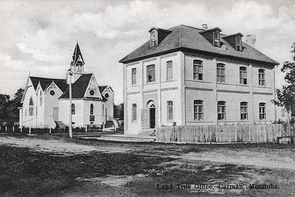 Postcard of Carman Land Titles Office with St. Andrew’s Presbyterian Church in the background at left