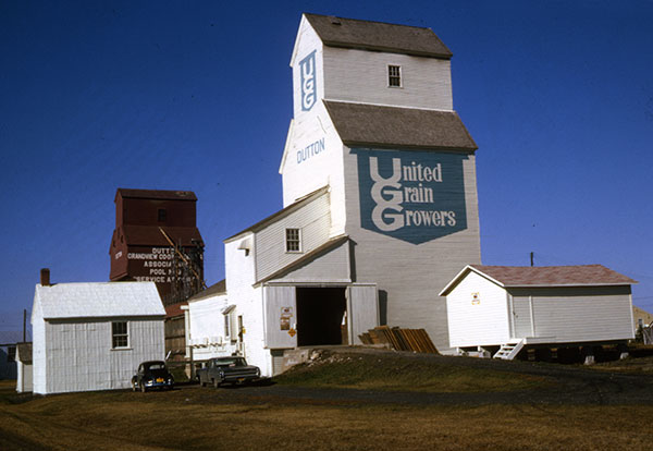 The former United Grain Growers grain elevator at Dutton Siding with the former Manitoba Pool grain elevator in the background