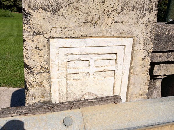 Provincial shield on railing of the concrete beam bridge at Ethelbert