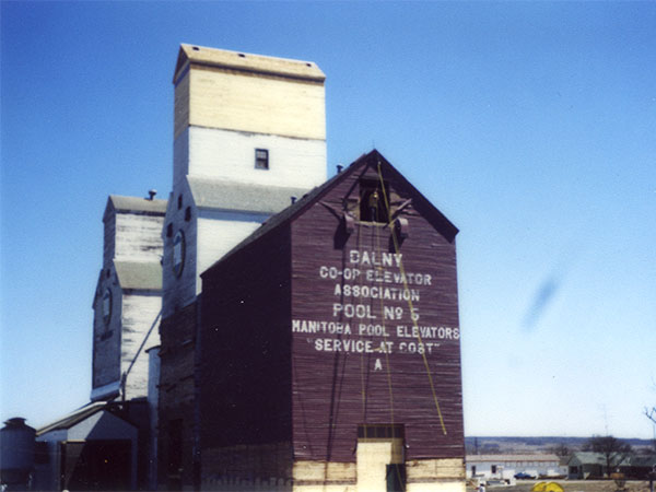 The former Manitoba Pool “A” grain elevator from Deloraine alongside the crib annex from Dalny with the original elevator in the background