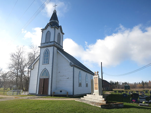 Hecla Island Lutheran Church with an associated monument and cemetery