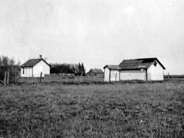 The original Isbister School building at left, with outbuildings