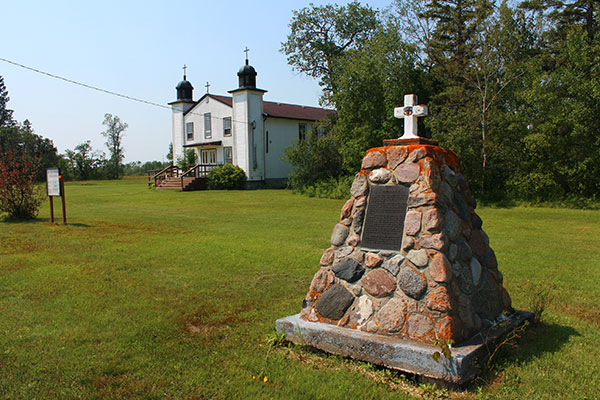 Komarno Pioneer Monument with Holy Trinity Ukrainian Catholic Church in the background