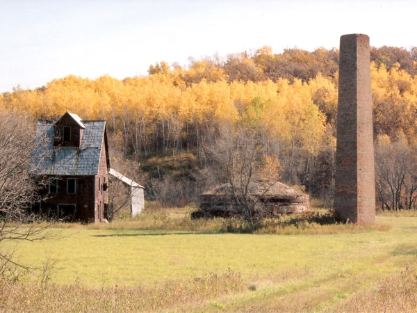 The former Leary Brickworks from the site gate showing, from left to right, the brick press building, drying shed, beehive kiln, and kiln chimney