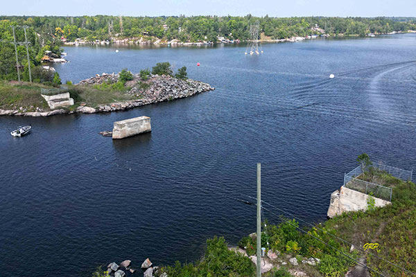 Aerial view of concrete piers of the former steel through truss bridge over the Lee River