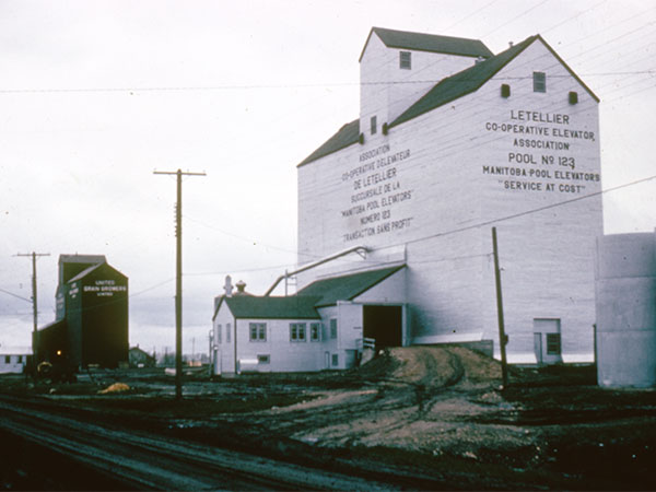 Manitoba Pool grain elevator at Letellier, with the United Grain Growers grain elevator in the left background