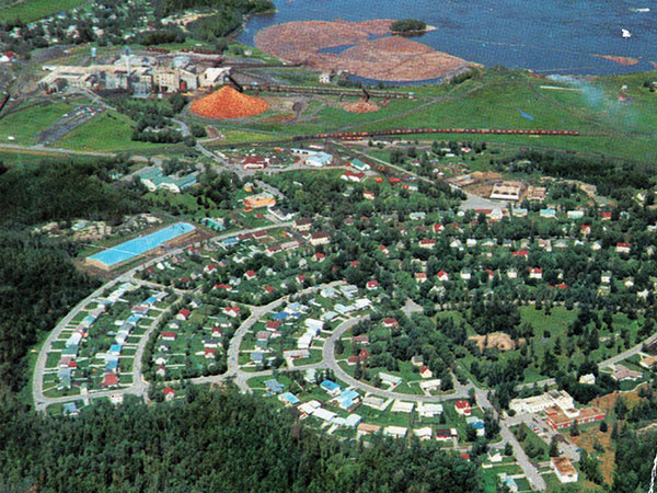 Aerial view of the Pine Falls paper mill in the background with the concentric rings of roads in the company-owned town in the foreground