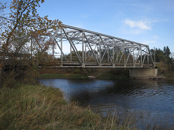 Steel truss bridge at its new site over the Whitemouth River