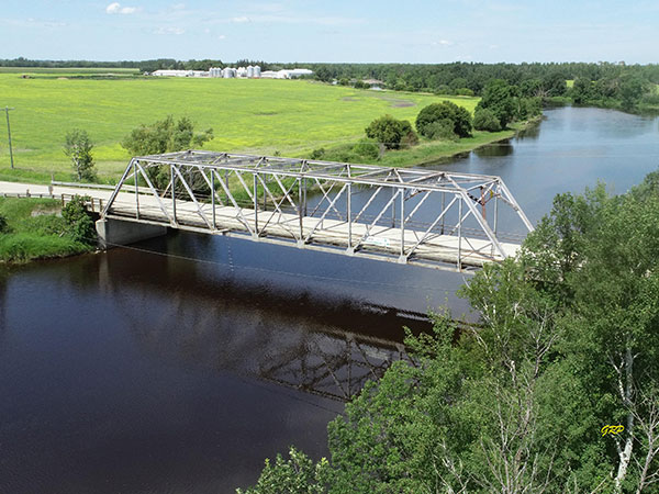 Aerial view of steel truss bridge over the Whitemouth River