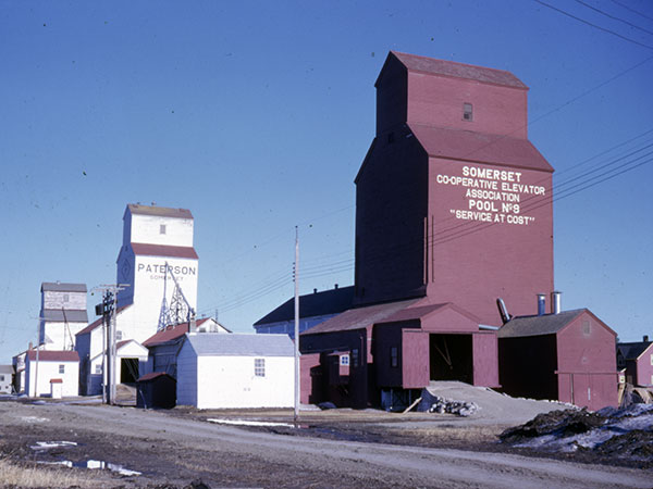 The 1926 Manitoba Pool grain elevator at the site, with Paterson and UGG grain elevators in the background