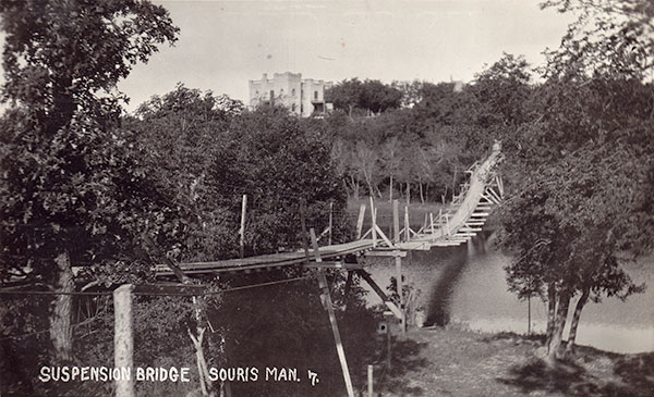 Postcard view of the Souris Suspension Bridge, with the 1910 Sowden residence, later the Hillcrest Museum, in the background