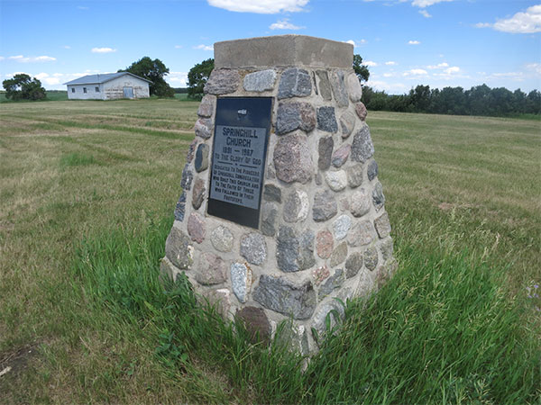 Springhill Church commemorative monument with community hall in background