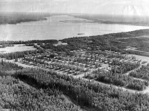 Aerial view of the Sundance town site with a coffer dam for the unbuilt Limestone Generating Station in the centre background