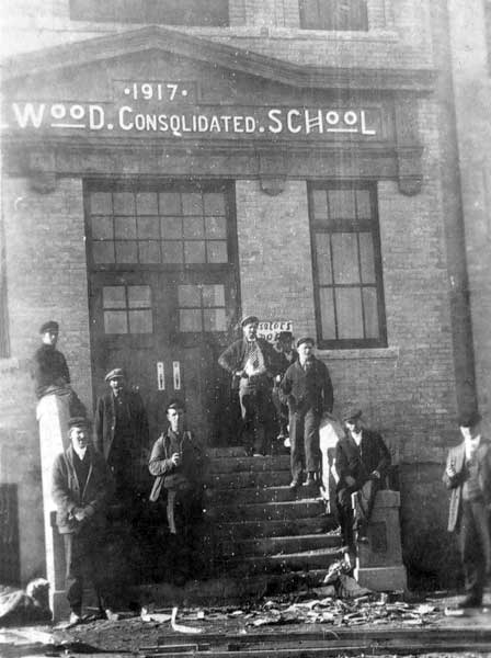 Construction workers at the entrance to Wellwood Consolidated School