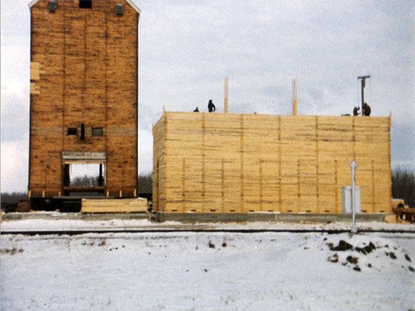 Construction of the Manitoba Pool grain elevator at Westroc using an elevator at left moved here from Langruth and a newly constructed annex