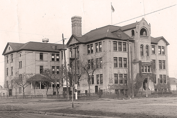 An undated photo of Strathcona School was clearly taken sometime after the major expansion of 1910&ndash;1911. Note the size of the trees
in the foreground. There was no vegetation of any sort on site when the school was first constructed in 1905.