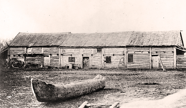 The Red River Settlement was in transition between the Pioneer and Commercial Eras when photographer Humphrey Lloyd Hime
visited in the fall of 1858 as a member of the Hind Exedition from Canada. Wood was the dominant material used for construction of
buildings, as seen in this view of Andrew McDermot&rsquo;s store near Upper Fort Garry.