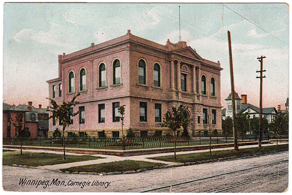 An historical postcard of the Carnegie Library on Winnipeg&rsquo;s William Avenue. In the background at right, across Ellen Street from the library, was Victoria School and its twin, Albert School, sat farther back.