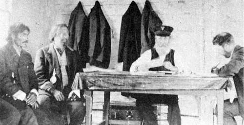 Commissioner John Semmens and clerk A. V. Thomas paying treaty at Nelson House, 12 July 1910.