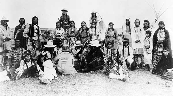 A group of Cree people in full dress, Saskatchewan, circa 1900.