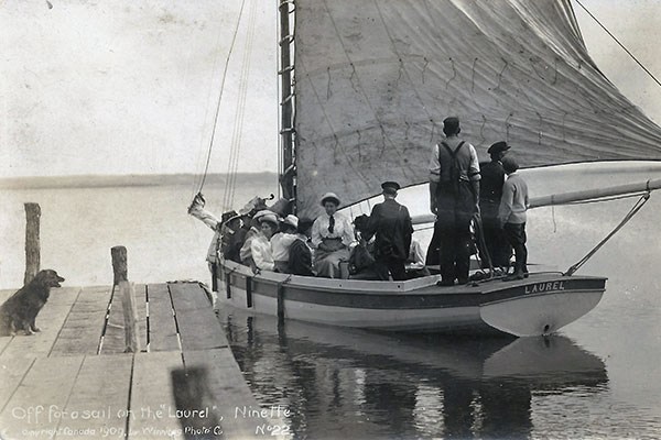 Postcard view of sailboat on Pelican Lake