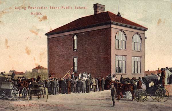 Postcard view of Melita School showing the start of construction for its expansion from four to eight classrooms