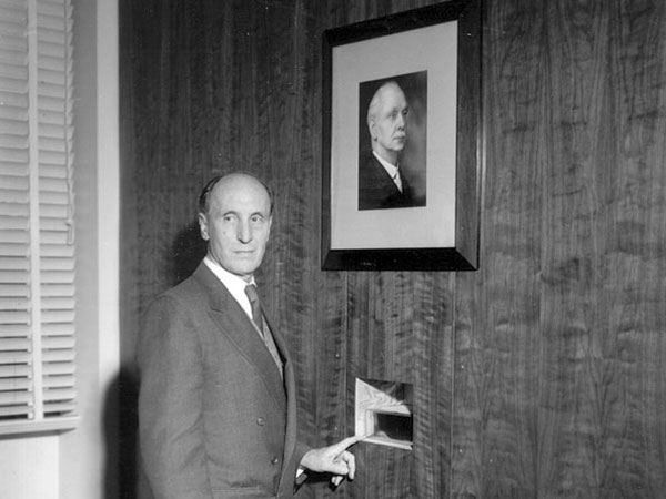Buller cremains being installed in a wall cavity, below a photograph of Buller, in the Buller Memorial Library at the now-demolished Agriculture Canada building at the University of Manitoba