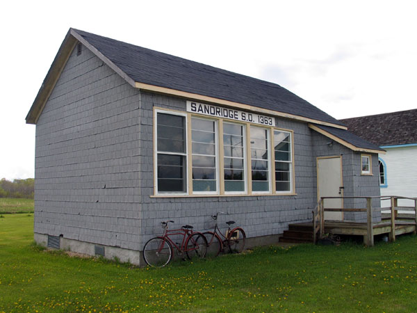 The former Sandridge School building, later moved to the Chatfield Museum