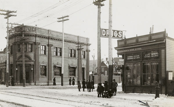 Postcard view of the Colcleugh’s Drug Store at right across from the Dominion Bank Notre Dame Branch at left