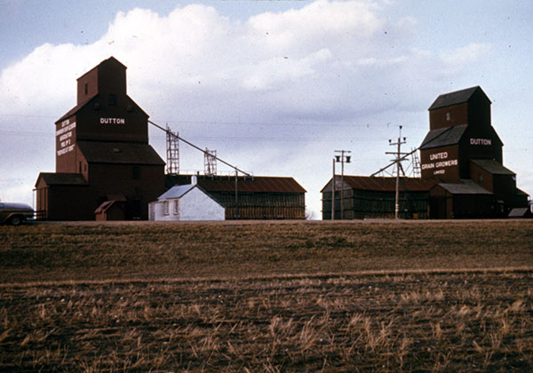 The former United Grain Growers grain elevator at Dutton Siding at right with the former Manitoba Pool grain elevator at left