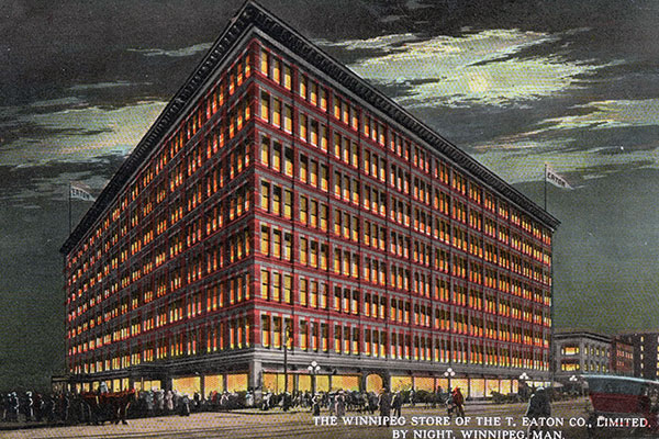 Postcard view of Eaton’s Department Store in Winnipeg at night
