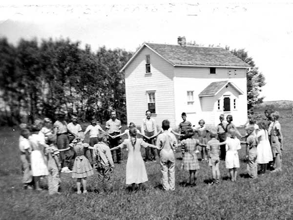 Students beside the original teacherage