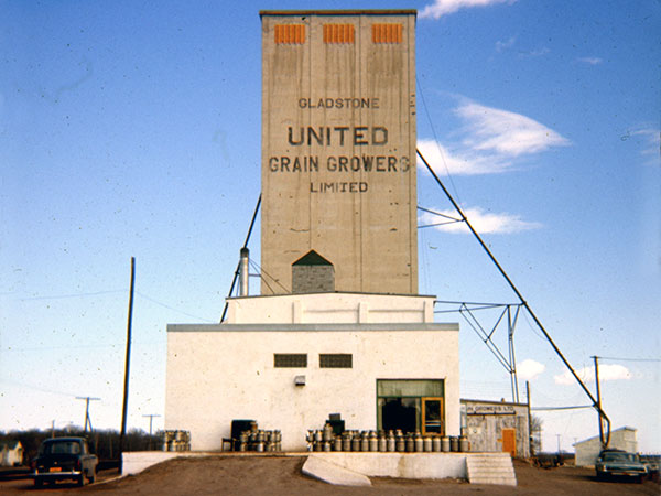 The former United Grain Growers grain elevator at Gladstone in the background, with the Gladstone Creamery in the foreground, all of which were at one time part of a flour mill