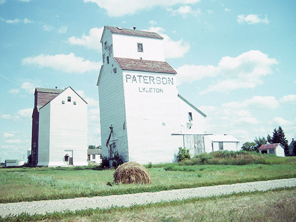 Now-removed Paterson grain elevator at Lyleton, with Manitoba Pool elevator in the background