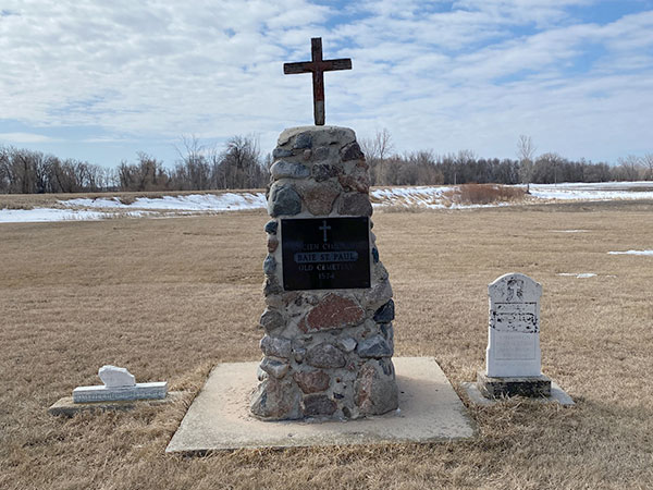 Belcourt memorial monument and two grave markers in the cemetery