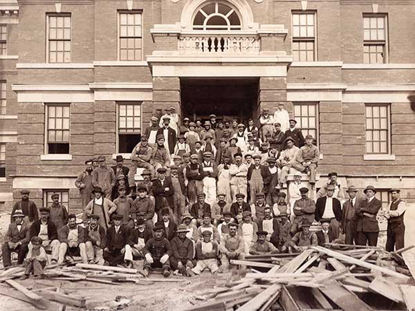 Workers in front of the Parkland Building during renovations