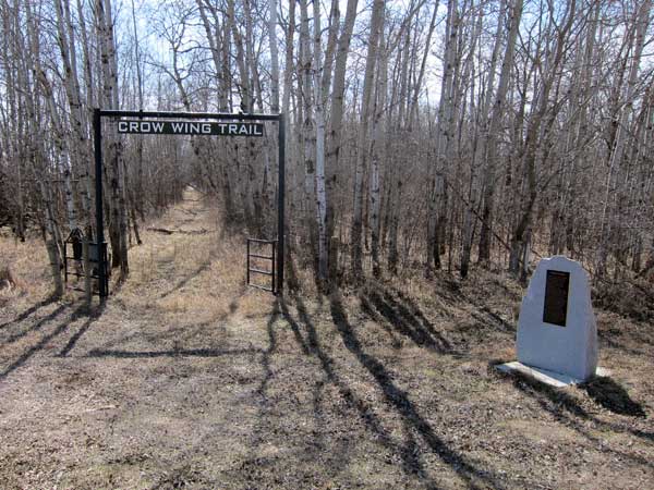 The Senkiw School monument beside a portion of the Trans-Canada Trail, formerly part of the historic Crow Wing Trail