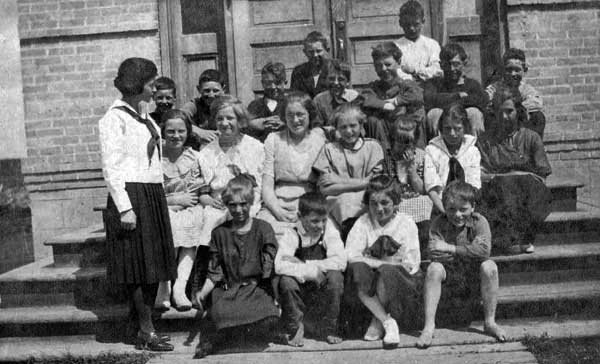 Teacher Marjorie Davidson with students on the steps of the Snowflake Consolidated School