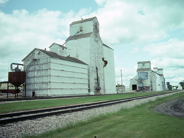 Manitoba Pool grain elevator at Swan Lake, with the United Grain Growers and Paterson Grain elevators in the background